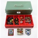 A tin of vintage badges including Girl Guides