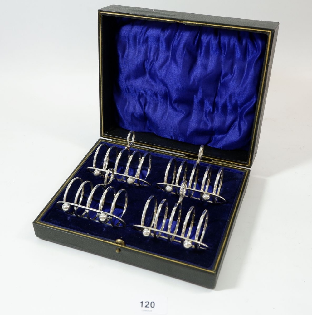 A cased set of four silver toast racks, Sheffield 1921, by MH & Co, 210g