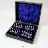 A cased set of four silver toast racks, Sheffield 1921, by MH & Co, 210g