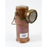 An antique copper foreman's mining lamp