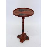 A small red lacquer occasional circular table, 31 cm diameter