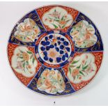 A Japanese Imari plate painted panels of flowers, 37cm