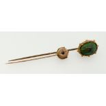 A Victorian 9ct gold stick pin set blue stone and a gilt metal scarab beetle stick pin