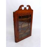 A Georgian provincial mahogany wall corner cupboard with swan neck pediment over astragal glazed