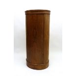 A rosewood unusual tall oval cabinet, 130cm tall