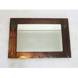 An Arts & Crafts copper framed mirror with stylised flower decoration over Ruskin style ceramic