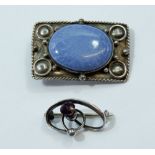 A Ruskin silver brooch, 4cm wide set lavender oval panel and a Charles Horner brooch set amethyst