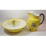 An Edwardian yellow toiletry bowl and jug printed birds