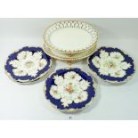Five Victorian dessert plates painted flowers on a gilt and blue ground and a pair of oval serving