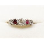 An 18 carat gold and platinum set ring with ruby and three diamonds (one ruby replaced), size K