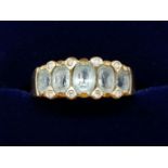 A 9 carat gold ring set five graduated aquamarines, 3.4g, size P to Q