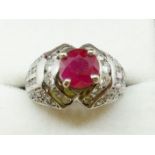 An 18 carat white gold ring set ruby on diamond set shoulders, size I, 8.6g