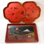 Two Japanese lacquer trays with painted decoration, the smallest 45 x 29cm