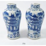 A pair of small 19th century Chinese blue and white baluster form vases painted landscapes with