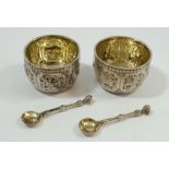 A pair of Victorian Scottish silver salts with all over embossed decoration by William Marshall,