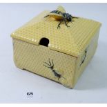 A large Fortnum & Mason honey pot with a honeycomb textured surface and decorated with bees, with