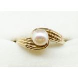 A 9 carat gold ring crossover set pearl, size T, 2.5g