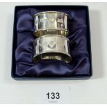 A pair of silver napkin rings, boxed