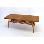 An vintage Ercol light elm coffee table with magazine rack under, 44 x 105cm