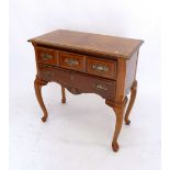 A reproduction low boy with crossbanding and two drawers all raised on cabriole supports, 76 x 40