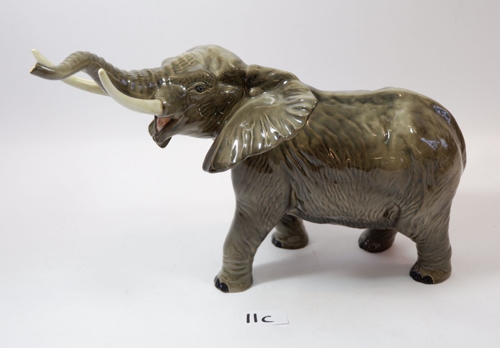 A large Beswick elephant, tusk a/f, 25cm tall