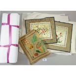 A box of embroidered table linen and two pairs of cotton sheets