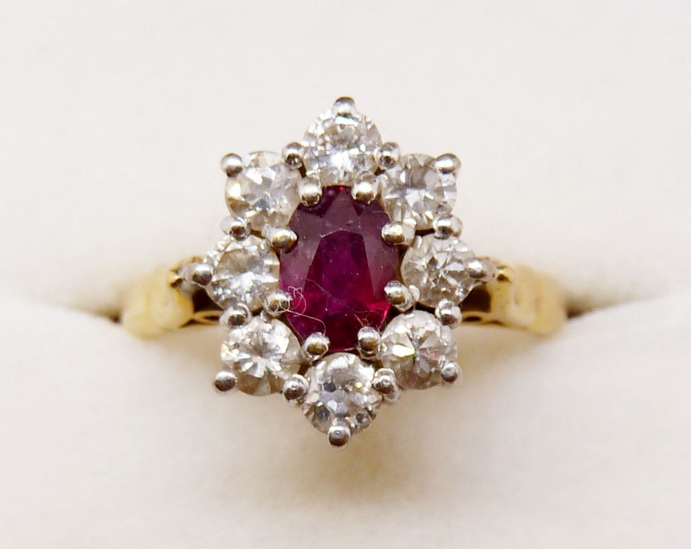 An 18ct gold ruby and diamond cluster ring, size N