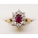 An 18ct gold ruby and diamond cluster ring, size N