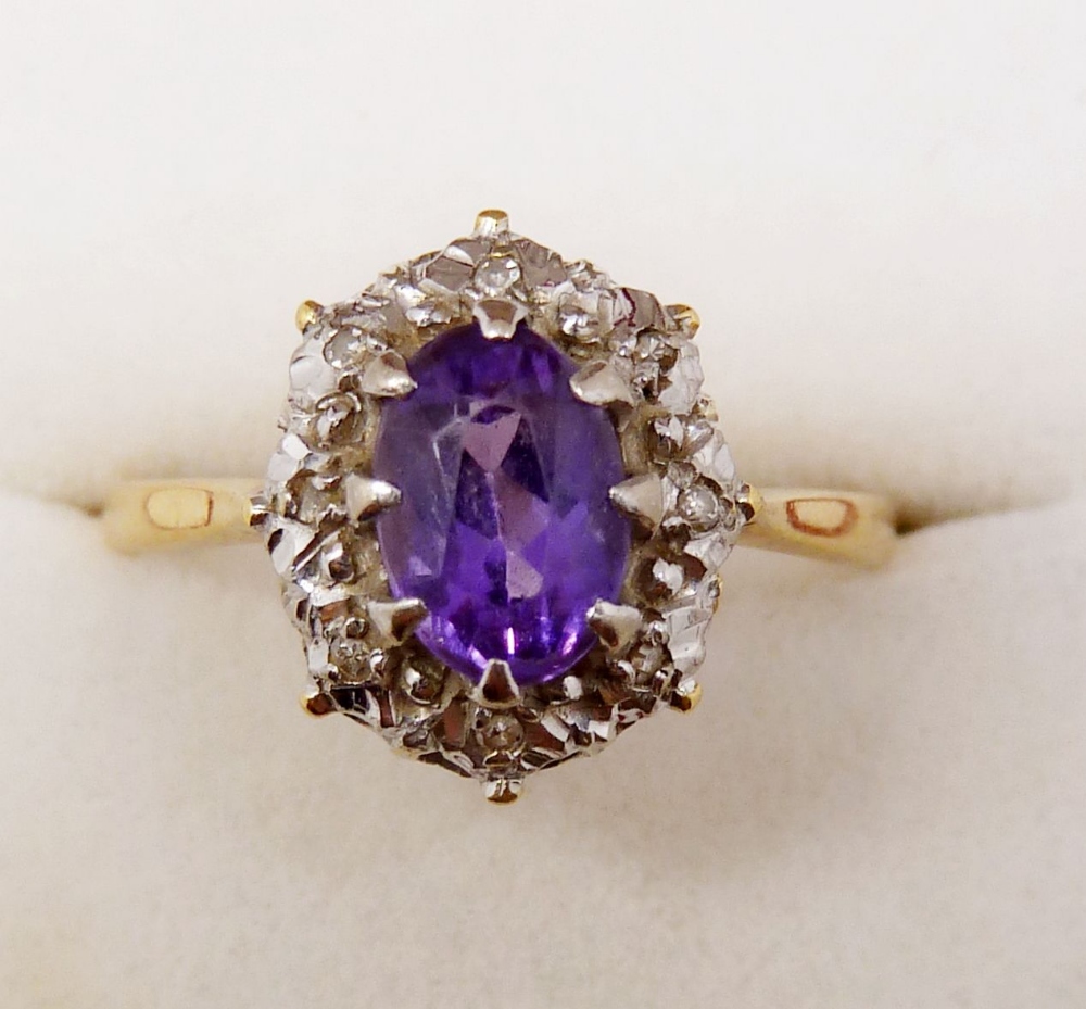 An 18ct gold amethyst and diamond cluster ring, size S to T, 3.7g