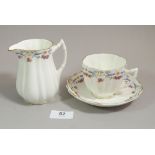 An Edwardian blue and pink floral tea set comprising: ten tea cups, twelve saucers, twelve side