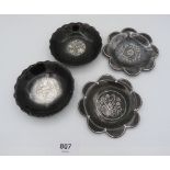 Four white metal inlaid pewter pin dishes with floral decoration, 9.5cm diameter