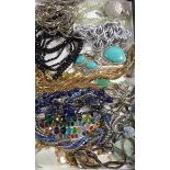 A tray of costume jewellery and faceted glass beads