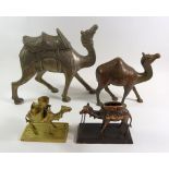 A group of four assorted metal camels