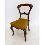 A Victorian mahogany balloon back chair with carved decoration