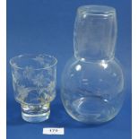 A glass engraved carafe and beaker and another engraved glass