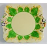 A Clarice Cliff dish decorated leaves and berries