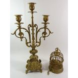 A brass candelabra and a brass miniature bird cage
