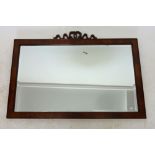 A walnut framed mirror with ribbon surmount, 83.5 x 53 cm