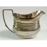 A silver ribbed cream jug, London 1903 by Barnards, 118g