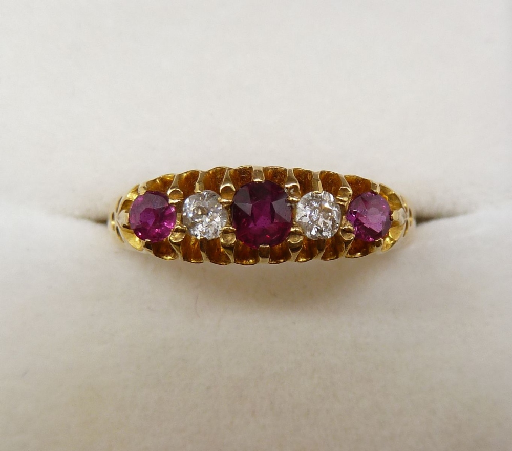 An 18 carat gold ring set three rubies and two diamonds, size O to P