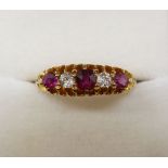 An 18 carat gold ring set three rubies and two diamonds, size O to P