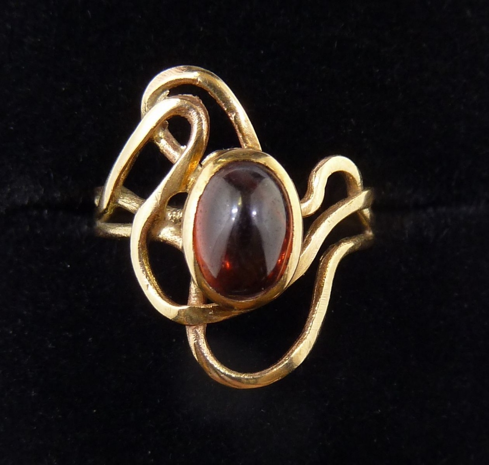 A 9 carat gold ring with asymmetrical set cabochon cut orange stone, size I, 2.1g