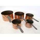 A set of five Victorian large copper saucepans, the largest 30cm diameter