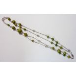 An early 20th century Arts & Crafts silver and green stone bead long necklace