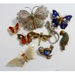 A vintage white metal filigree butterfly brooch and various other butterfly and animal brooches