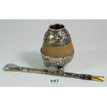 An Argentinian silver mounted yerba mate tea cup and straw with embossed and inlaid decoration,