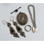 An oval silver locket engraved bird - unmarked and various silver jewellery including earrings,