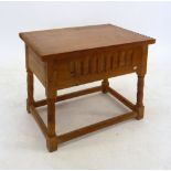 A light oak carved rise top occasional table, 58cm wide