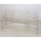 A 19th century iron garden bench with interlaced back