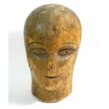 A 1920's Art Deco carved wood milliners block with incised features, 17cm tall